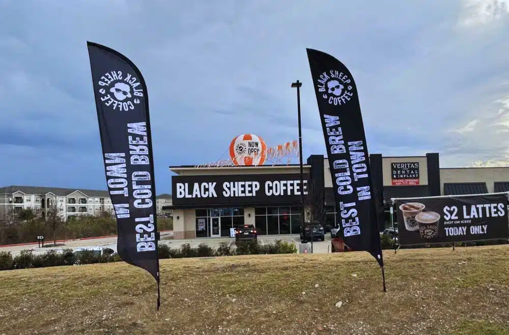 black custom advertising flags at coffee shop